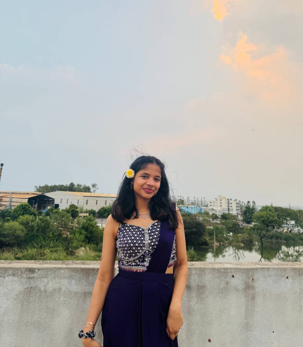 Image 1 of 2 Woman standing in front of beachy background smiling